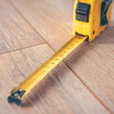 Construction tape measure on a wooden floor