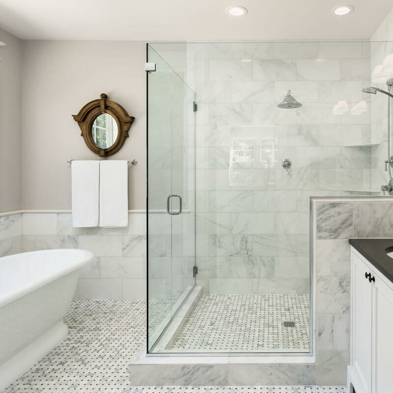 Beautiful bathroom, white tile floor, white tile shower with glass doors